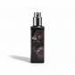 Black spray bottle with floral design on a white background