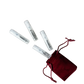 Set of small cylindrical containers with a red drawstring bag on a white background
