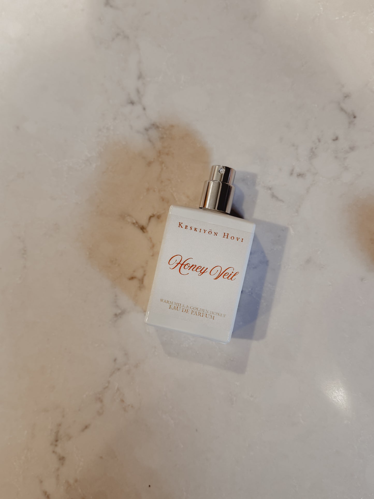 Perfume bottle labeled 'Honey Yol' on a marble surface