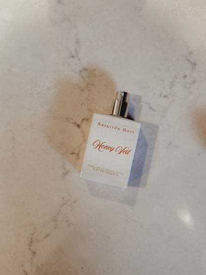 Perfume bottle labeled 'Honey Yol' on a marble surface