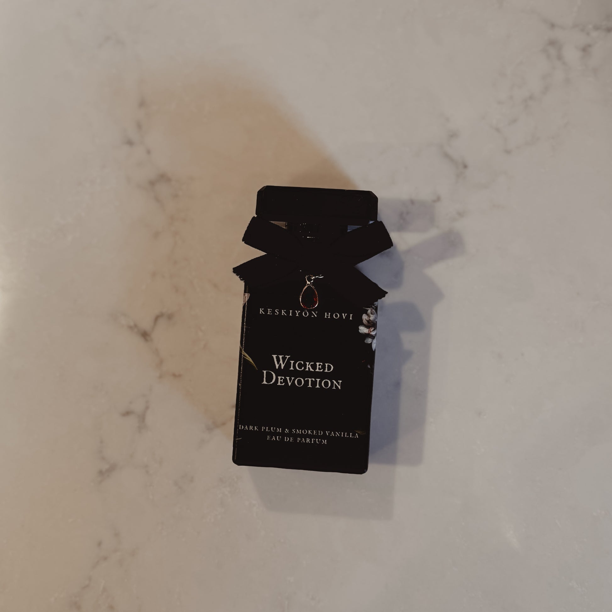 Kerrison Home Wicked Devotion candle packaging on a marble surface