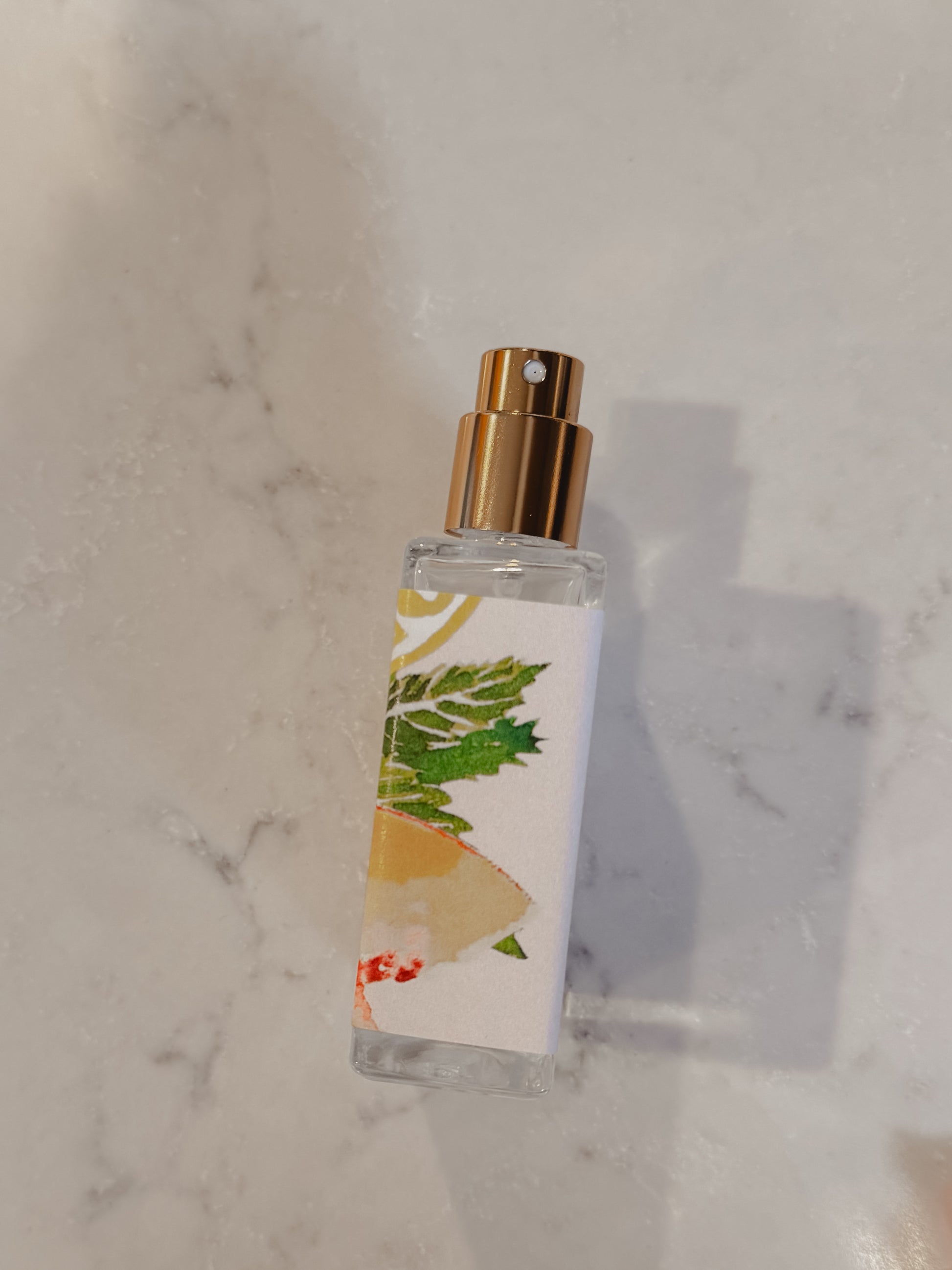 Small bottle with a gold cap on a marble surface