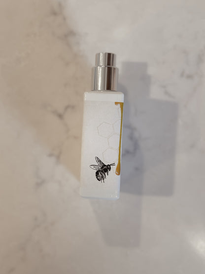 White bottle with silver cap on a marble surface