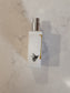 White bottle with silver cap on a marble surface