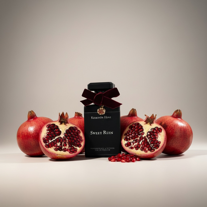 Bottle of 'Sweet Ruin' with pomegranates on a neutral background