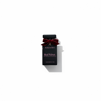 Black perfume bottle labeled Red Velvet product with a red bow on a white background