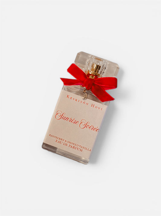 Perfume bottle with a red bow on a white background