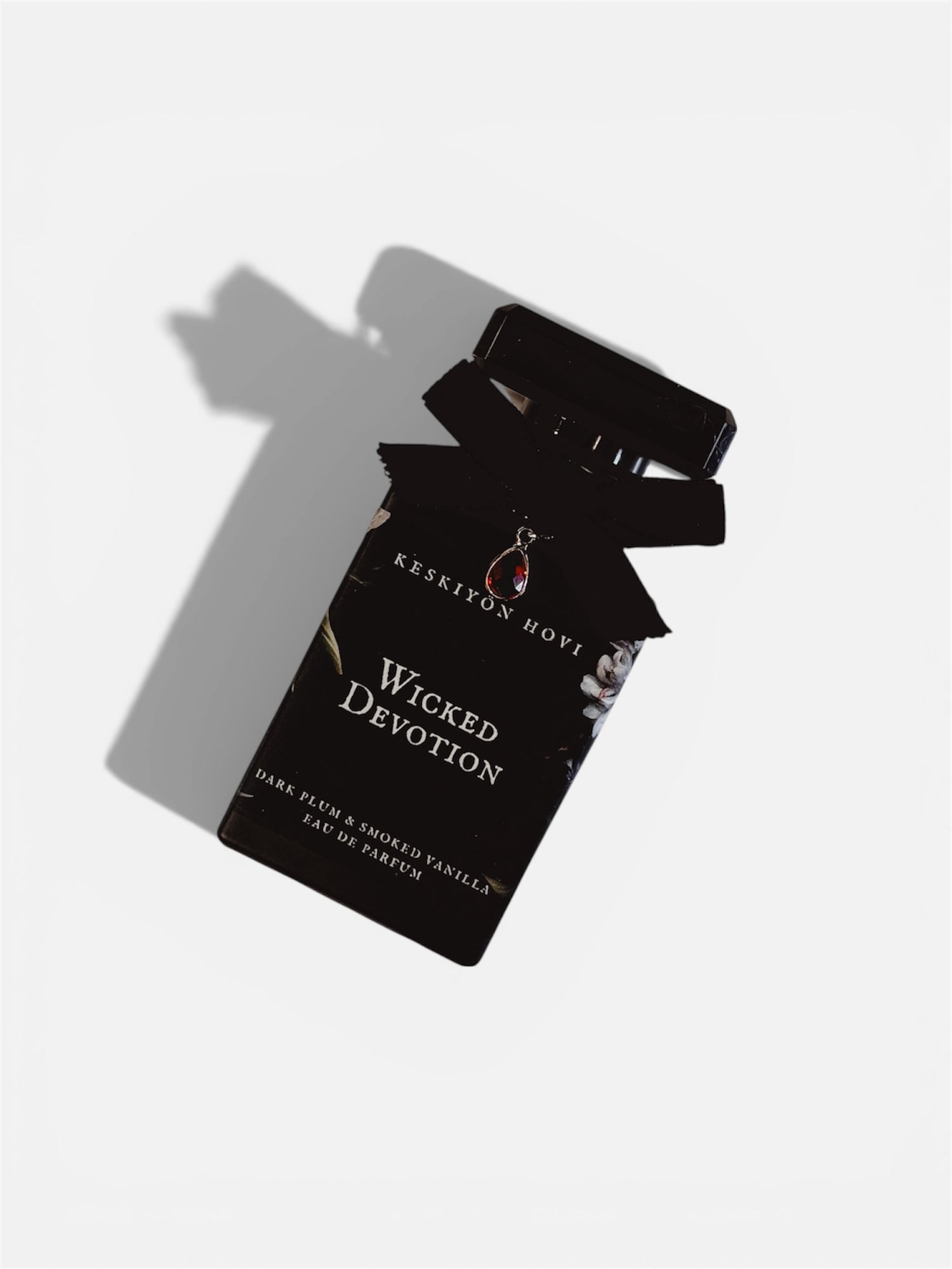 Perfume packaging with 'Wicked Devotion' label on a white background