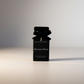 Black perfume bottle with bow and 'Kerstin Hovin Midnight Hour' text on a light background
