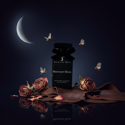 Perfume bottle labeled 'Midnight Hour' with dried roses and flying butterflies under a dark moonlit sky.