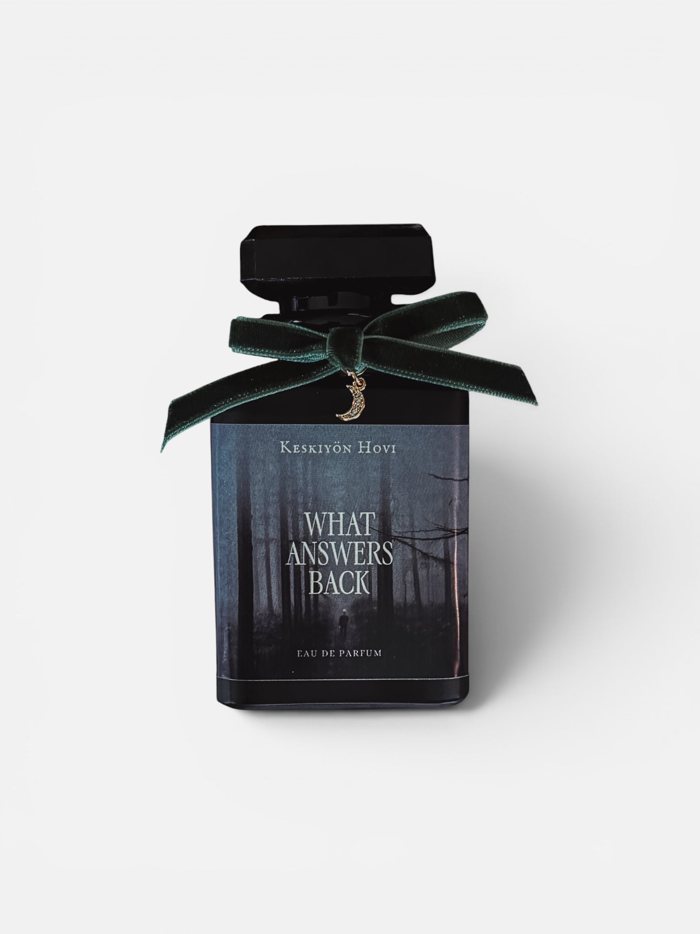 Perfume bottle with a black label and green ribbon on a white background