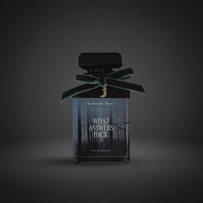 Perfume bottle with a green ribbon on a dark background